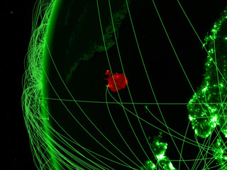 Iceland from space on green model of Earth with international networks. Concept of green communication or travel.