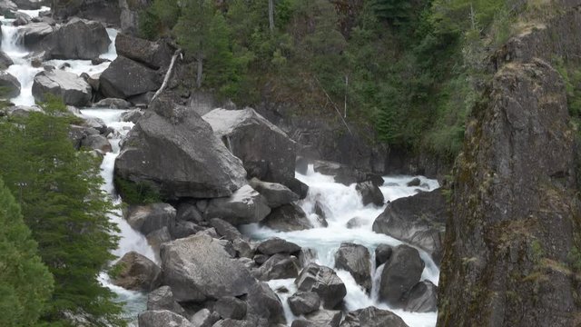 Move up the stream of the white river tht slides through the rocks.