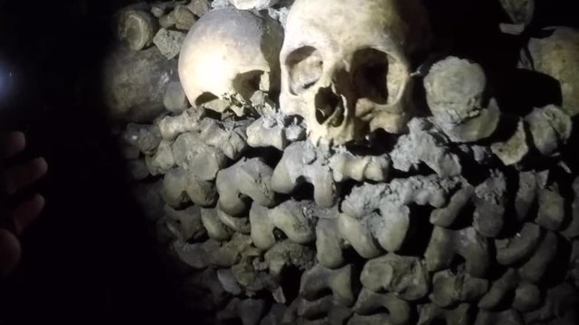 Closeup of piles of skulls and bones in Catacombs