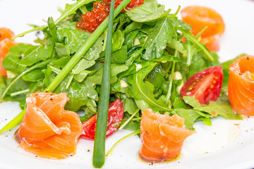 fresh salad on a plate with salmon