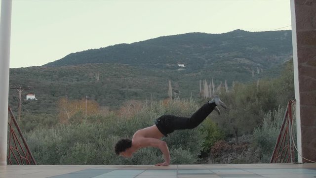 Bodyweight fitness handstand to V-sit exercise in beautifully scenic location
