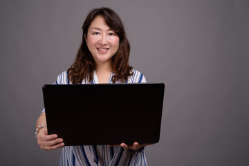 Mature beautiful Asian businesswoman using laptop computer