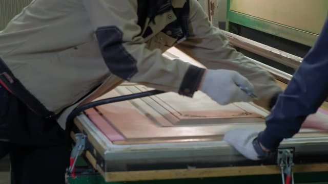 a man, a worker cleans a wooden blank from the dust, a door.production of interior doors of wood