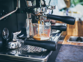 Portafilter wiyh beaker mug  on coffee machine