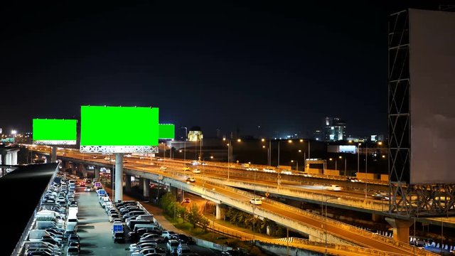 Green screen of advertising billboard on expressway during the twilight with city background in Bangkok, Thailand.