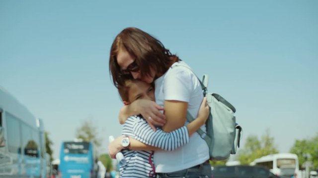 Mom Hugs Daughter. Daughter Surprises Mother With A Loving Hug From Behind