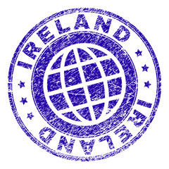 IRELAND stamp imprint with distress texture. Blue vector rubber seal print of IRELAND label with unclean texture. Seal has words arranged by circle and globe symbol.