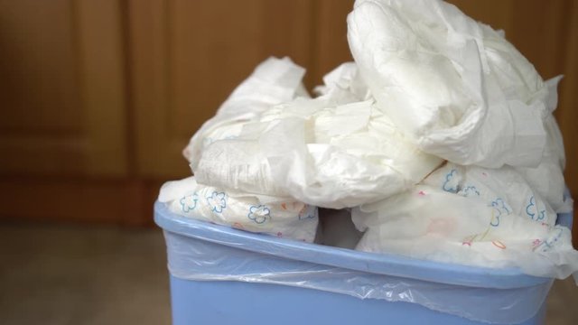 Diaper wastebasket. Disposable diapers in the garbage bin. Throw away diaper