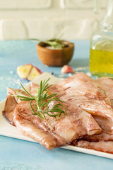 Fresh Squid, Various Spices and Olive Oil on blue concrete or stone table. Copy space.