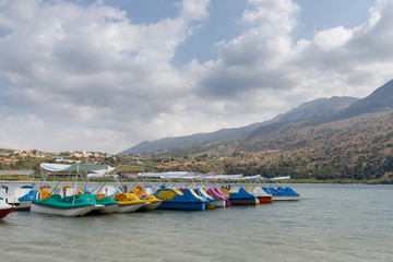 Fototapeta na wymiar colorful boats and catamarans on the lake in the kournas mountains in Crete, Greece