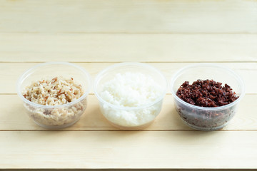 Three kinds of cooked rice in plastic bowl