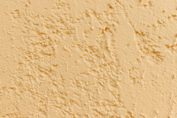 the background image of a textured surface  orange plaster  