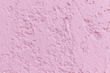 the background image of a textured surface of pink plaster