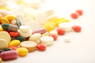 Different colorful tablets at white background