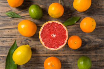 Fresh citrus fruits on black wooden background