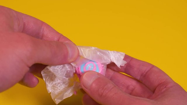 Opening a Piece of Taffy Candy