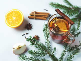 Winter warming mulled wine with spices and orange slice and Apple with Christmas tree branches