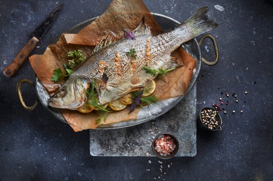 Bass filled with herbs and lemon slices (seen from above)