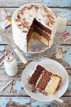 Layer cake with butter cream, chocolate flakes and an elf decoration, sliced