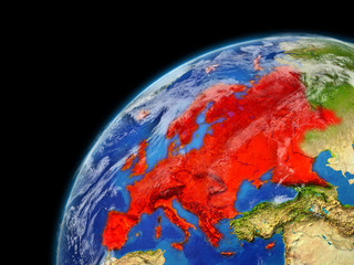 Europe on model of planet Earth with very detailed planet surface and clouds. Continent highlighted in red.
