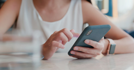 Woman use of mobile phone in coffee shop