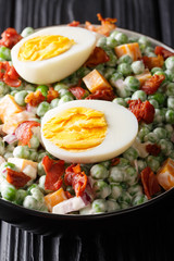 English Pea Salad is a hearty side dish with eggs, bacon, minced red onion, and cheddar cheese all blended together with a creamy dressing. vertical
