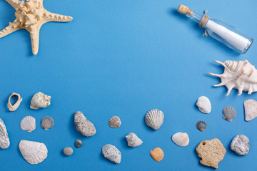 Sea shells and starfish in a bottle on a turquoise background. Place under your text.