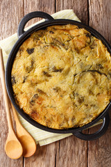 Homemade English Bubble & Squeak of baked mashed potatoes with cabbage and Brussels sprouts in a pan. Vertical top view