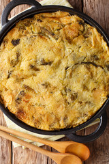 English vegetarian Bubble & Squeak of potatoes with cabbage and brussels sprouts close-up in a pan. Vertical top view