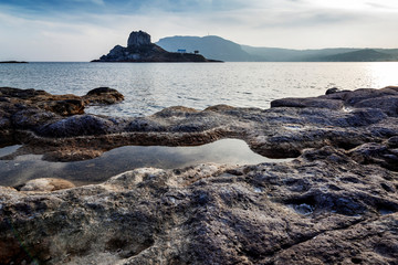 Kos island, Greece, coast view of Kefalos village, island of Kastri and an orthodox temple at sunset