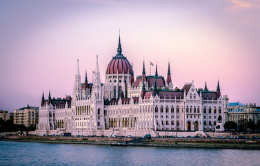 Fototapeta na wymiar The Hungarian Parliament Building (a.k.a. the Parliament of Budapest) a landmark and popular tourist destination in Budapest. It lies in Lajos Kossuth Square, on the bank of the Danube.