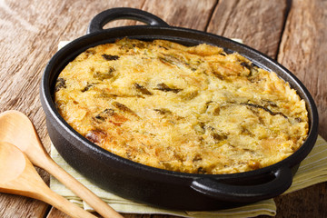 English food Bubble & Squeak from baked mashed potatoes with cabbage and Brussels sprouts close-up in a pan. horizontal