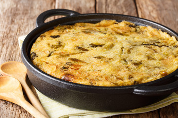 Homemade English Bubble & Squeak of baked mashed potatoes with cabbage and Brussels sprouts in a pan. horizontal