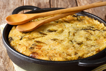 English Bubble and Squeak of baked mashed potatoes with cabbage and brussels sprouts close-up in a pan. horizontal