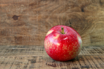 Spill pour red apple on wooden background