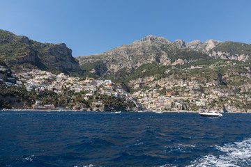 Obraz premium Colourful Positano, the jewel of the Amalfi Coast, with its multicoloured homes and buildings perched on a large hill overlooking the sea. Italy