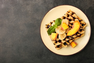 Belgian waffle with fruit and chocolate