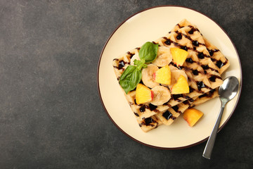 Belgian waffle with fruit and chocolate