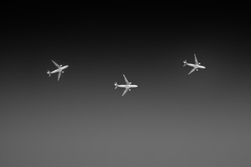 Monochrome conceptual three planes flying in different directions.