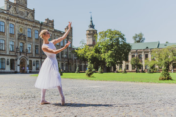 Fototapeta premium Ballet dancer at city streets, concept of elegant ballerina, inspired girl outdoor