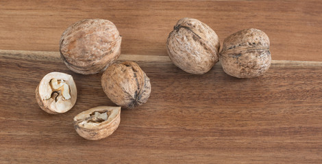 Several walnuts on a wooden board