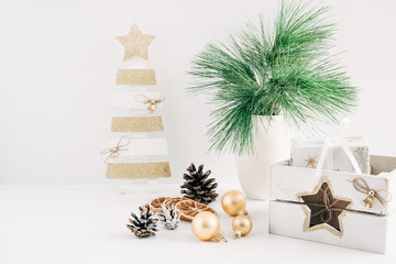 Home Decor, Interior. Decorative wooden Christmas tree, vase with fir branches, cones, Christmas...