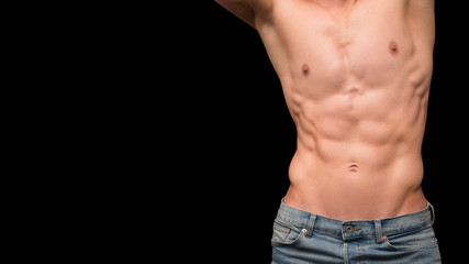 Shirtless male torso over dark background. Shape male abdomen muscles.