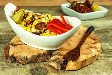 Mixed egg with sausage in a ceramic dish. Breakfast from eggs. Healthy food. Protein for breakfast.