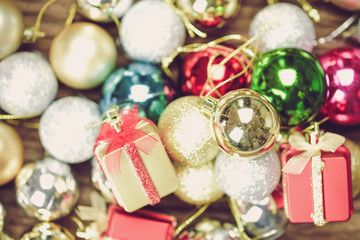 Christmas Ball and box colorful decorations on a wood background