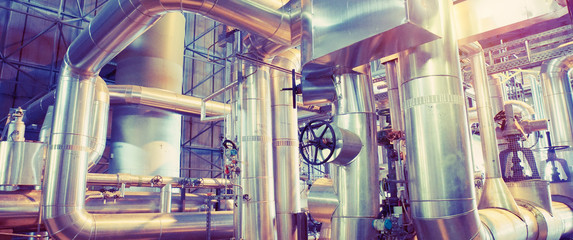Equipment, cables and piping as found inside of a modern industrial power plant