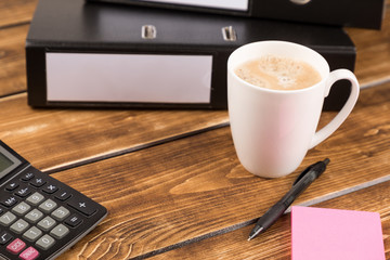 Fototapeta na wymiar desk with coffee cup, folder, calculator and pen