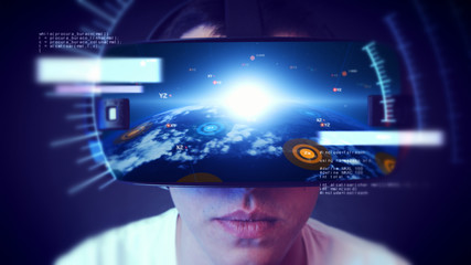 Young man wearing VR headset and experiencing virtual reality. Technology related digital earth network concept.