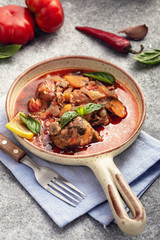 Stewed chicken with vegetables in ceramic pan © Yingko