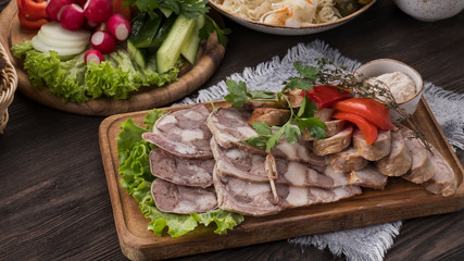 Sliced pork saltisons with homemade sausage on cutting board. Copyspace